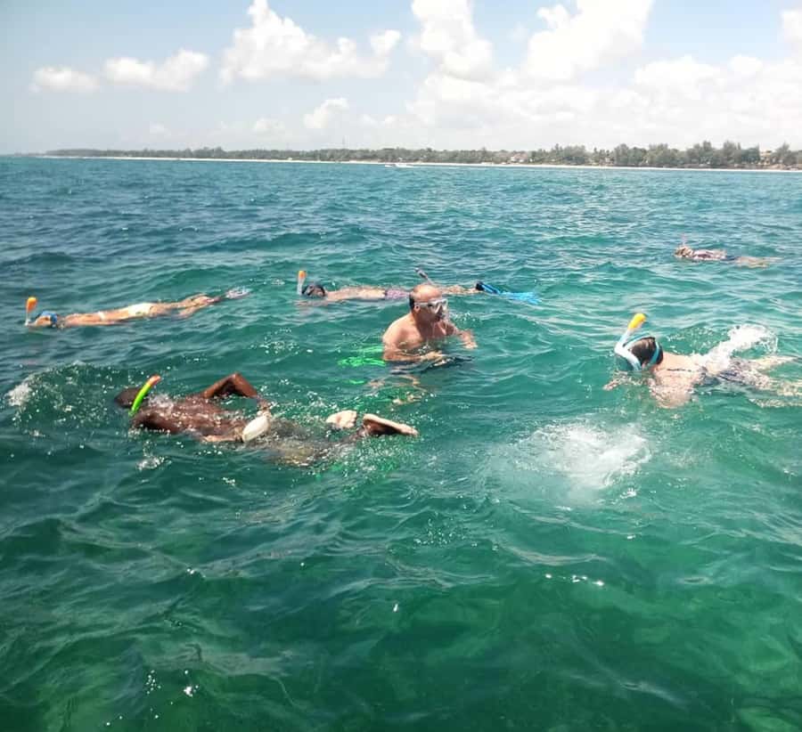 Diani Beach: Glass-Bottom Boat Cruise to Robinson Island - A glass floor and a captain beneath your feet